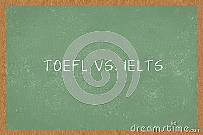 Word TOEFL vs. IELTS , Green Chalkboard background. Test of English as a Foreign Language exams Stock Photo