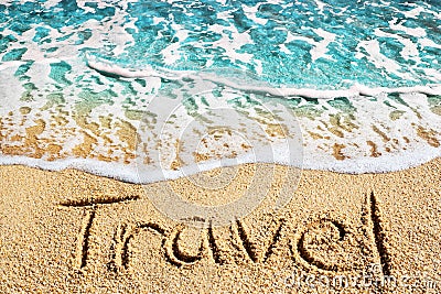Word TRAVEL written on yellow sand, blue sea water wave, white foam top view close up, handwriting letters text, summer vacation Stock Photo
