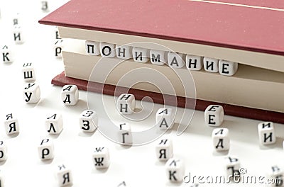 Word understanding written win cyrillic letters between book sheets and cyrillic letters scatter on white background concept abstr Stock Photo
