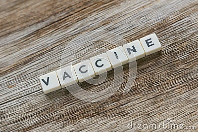 Word Vaccine alphabet on wooden background Stock Photo