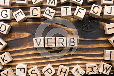 word verb composed of wooden cubes with letters Stock Photo