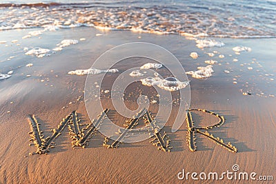 The word `war` on the sea sand, written with stick on the beach with foam Stock Photo