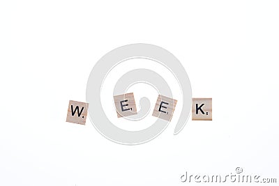 Word week arranged from wooden blocks on white background. Game Editorial Stock Photo