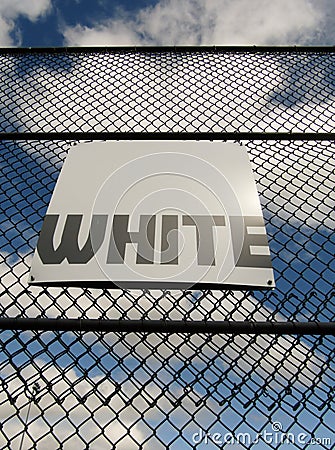 Word white on white sign board on mesh fence Stock Photo