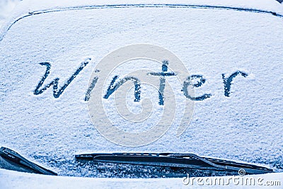 Word winter on the frozen glass of a car windshield. Car winter season concept Stock Photo