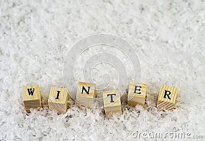 The word winter made of letters on wooden cubes on a snow background 2 Stock Photo