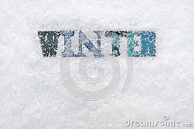 The word WINTER on a snow background Stock Photo