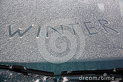 Word winter written on snowy windshield Stock Photo