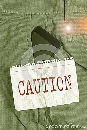 Word writing text Caution. Business concept for Care taken to avoid danger or mistakes Warning sign Prevention Smartphone device Stock Photo