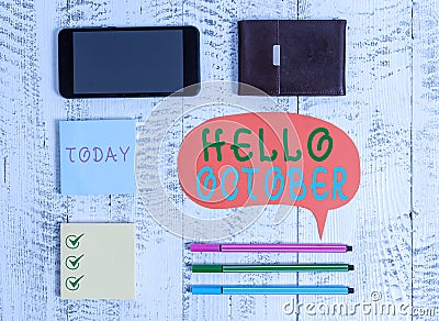 Word writing text Hello October. Business concept for Last Quarter Tenth Month 30days Season Greeting Smartphone pens Stock Photo