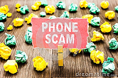 Word writing text Phone Scam. Business concept for getting unwanted calls to promote products or service Telesales Clothespin hold Stock Photo