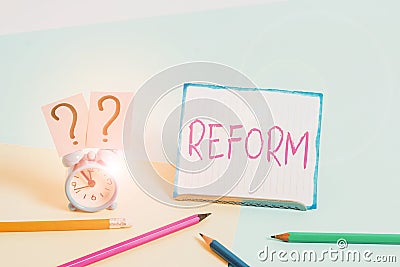 Word writing text Reform. Business concept for to amend or improve by change of forms or removal of faults Mini size alarm clock Stock Photo