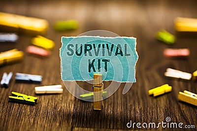 Word writing text Survival Kit. Business concept for Emergency Equipment Collection of items to help someone Clothespin holding bl Stock Photo