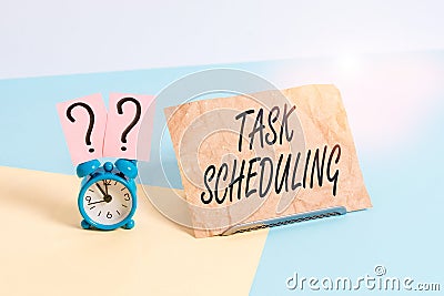 Word writing text Task Scheduling. Business concept for The assignment of start and end times to a set of tasks Mini size alarm Stock Photo