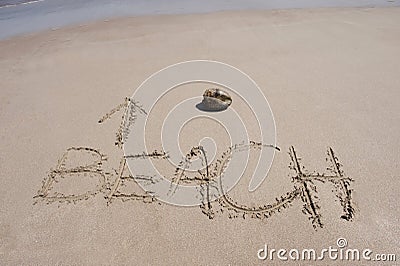 Word written in sand on tropical beach & coconut Stock Photo