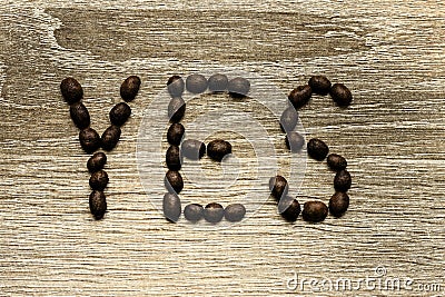 The word `Yes` laid out with roasted arabica coffee beans Stock Photo