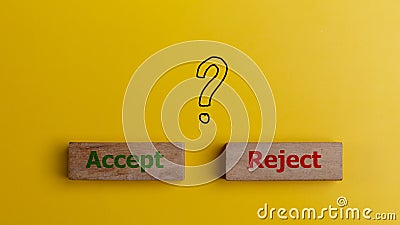 The words accept and reject on wooden blocks with question mark symbols. Dilemma or choice between to approve or to refuse an Stock Photo