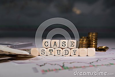 Words CASE STUDY composed of wooden letter. Stacks of coins in the background Stock Photo