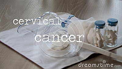 Words CERVICAL CANCER. Plastic vaginal speculum, pills and other tools in the background Stock Photo