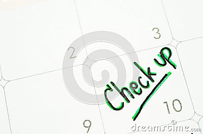 The words Check Up written on a calendar planner. Stock Photo