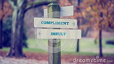 Words Compliment and Insult in a conceptual image Stock Photo