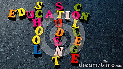 The words Education, School, Student, College built of colorful wooden letters on a dark table. Stock Photo