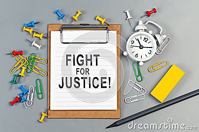 The words Fight for Justice written on a white notebook Stock Photo
