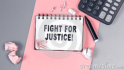 The words Fight for Justice written on a white notebook. Closeup of a personal agenda. Top view. Office concept Stock Photo