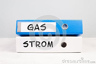 The words gas and electricity are standing in german language on the folders, increasing prices, high living expenses, financial Stock Photo