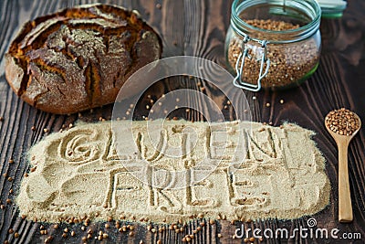 Close-up words `gluten free` on a buckwheat flour Stock Photo