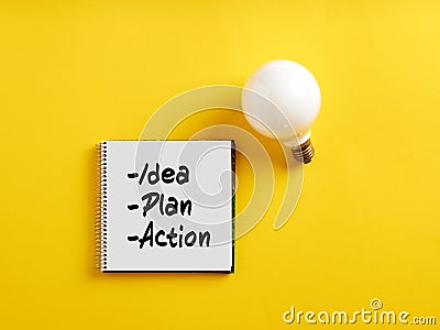 The words idea, plan, and action on notepad with a light bulb. Business action plan or creative idea planning strategy Stock Photo