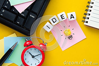 The words idea on yellow background with a light bulb Stock Photo