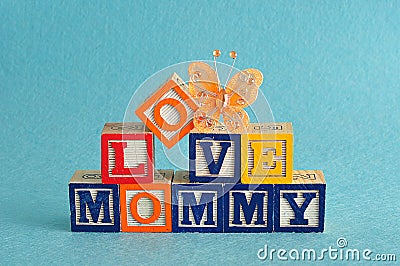 The words love mommy spelled with alphabet blocks Stock Photo