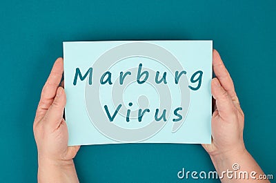 The words Marburg virus are standing on a paper, dangerous infectional disease, hemorrhagic fever, medical diagnosis, health issue Stock Photo