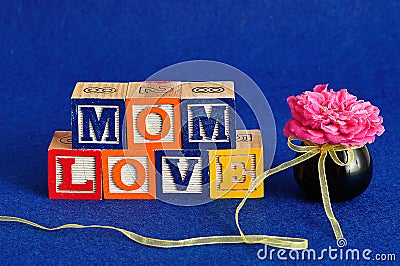 The words mom love spelled with alphabet blocks Stock Photo