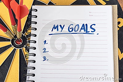 Words my goals on notebook with dart target background Stock Photo