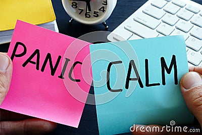 Words panic and calm on pieces of paper. Problem solving. Stock Photo