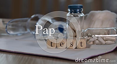 Words PAP TEST composed of wooden dices. Pills, documents and a pen in the background Stock Photo
