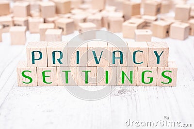 The Words Privacy Settings Formed By Wooden Blocks On A White Table Stock Photo