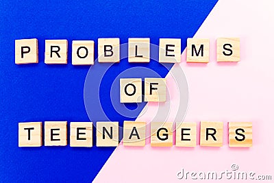 Words problems of teenagers. Wooden blocks with an inscription on top on a yellow background. Social problems of teenagers Stock Photo