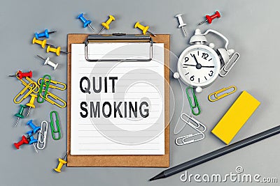 The words Quit Smoking written on a white notebook Stock Photo