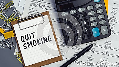 The words Quit Smoking written on a white notebook Stock Photo