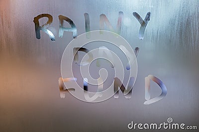 Words RAINY DAY FUND written by hand on wet glass at morning with blurry street light background Stock Photo