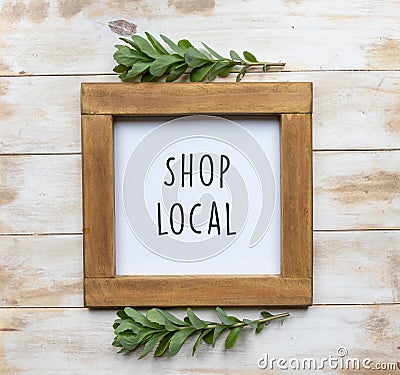 The words `Shop Local` in black text on a framed white board Stock Photo