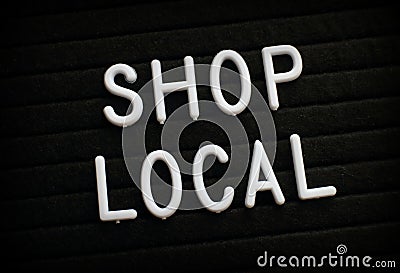 The words Shop Local on a Notice Board Stock Photo