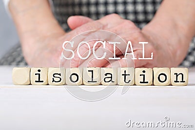 Words SOCIAL ISOLATION composed of wooden made dices Stock Photo