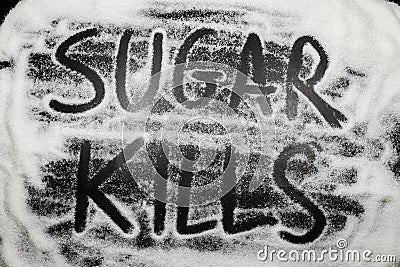 Words Sugar kills written in and with sugar grains, sugar health Stock Photo