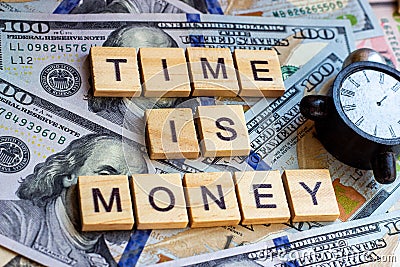 Words Time is Money as a proverb on dollar usa background with black and white clock. Stock Photo
