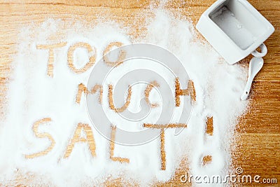 Words TOO MUCH SALT handwritten on salt Stock Photo