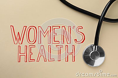 Words Women`s Health and stethoscope on beige background, top view Stock Photo